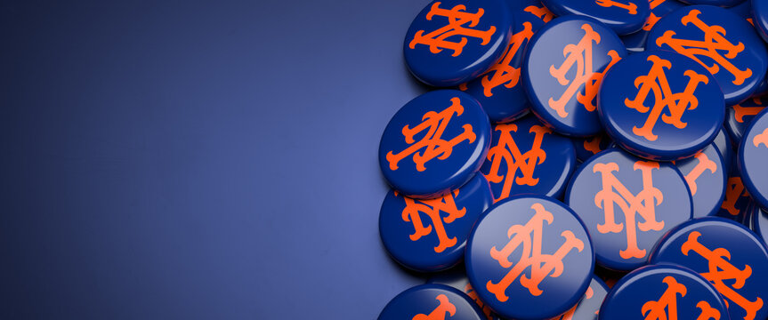 Logos of the American Major League Baseball Team New York Mets on a heap on a table.