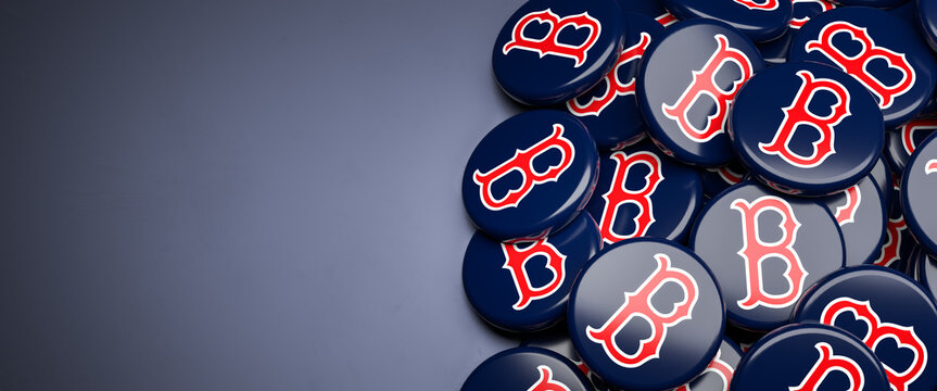 Logos of the American Major League Baseball Team Boston Red Sox on a heap on a table.