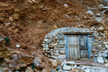 An old door closing a hidden entrance to the inside of the rock