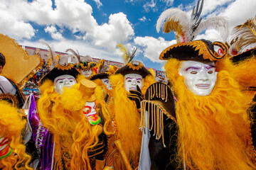 Dancers with typical devil costumes and other representations celebrate the festival of the Virgen...