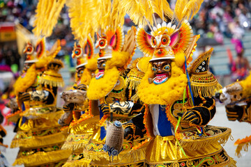 Dancers with typical devil costumes and other representations celebrate the festival of the Virgen...