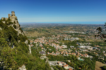 Naklejka premium View of the old castle on a high mountain with the modern city below.