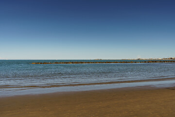 Calm sea overlooking a smooth sandy beach