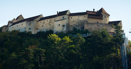 Fototapeta na wymiar Impressive rocky landscape with medieval Rasnov Fortress, Romania.