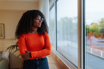 Cheerful African American woman in apartment.