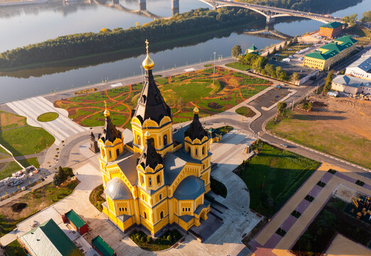 Cityscape of Nizhny Novgorod in morning. Alexander Nevsky Cathedral and bridges across Oka River visible from above.