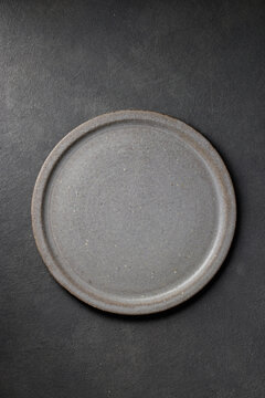 empty plate on dark grey background
