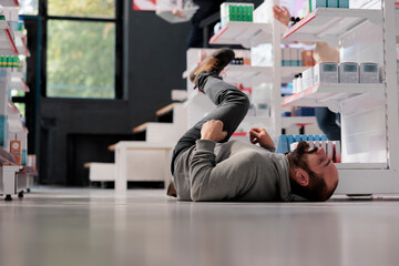 Drugstore customer falling during epileptic attack with foaming at mouth, fainting in apothecary....