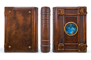 Large aged brown leather book with the Moon in the center of the cover stay up isolated