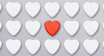 many white hearts and one red - concept of choosing the right person