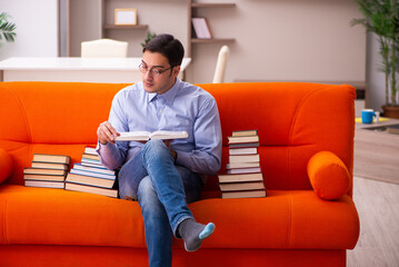 Young male student preparing for exams at home