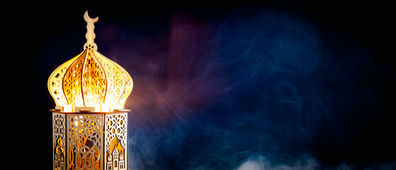 Arabic lantern in shape of a mosque on dark background. Ramadan Kareem banner design.