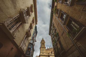 Street photo of old quarter of Pamplona with clock tower, Navarre, Spain