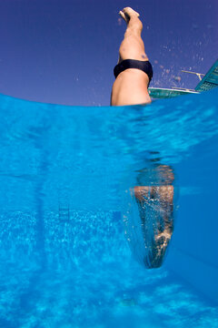 Diver jumping from springboard and entering water, Key Largo, Florida