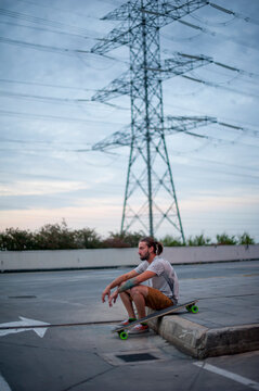 Boy posing with skateboard in hand