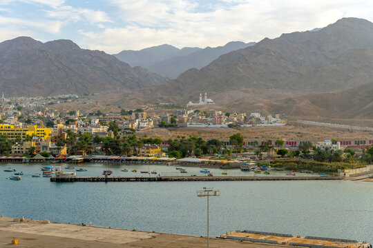 Morning sunlight on the seaside port city of Aqaba Jordan with the cruise port and Sheikh Zayed Mosque in view.