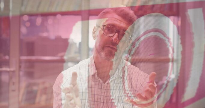 Animation of data processing text over caucasian businessman working in office