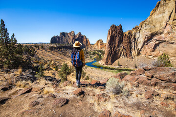A Girl standing and looking at Beautiful Landscape Scenic of Road Following River Through Valley...