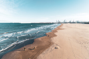 beach in the late afternoon with harbor in the background, Valencia spain