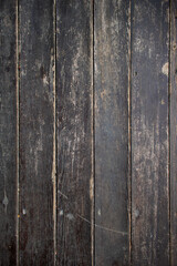 texture of a weathered and worn dark wooden surface of an old fence or parquet floor - textured medieval background for a wallpaper or a vertical banner of a traditional rustic product