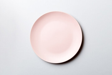 Top view of isolated of colored background empty round pink plate for food. Empty dish with space for your design