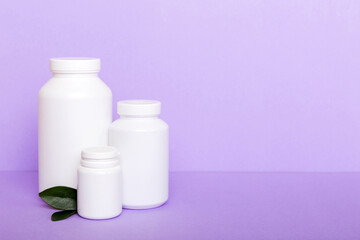 supplement pills with medicine bottle health care and medical top view. Vitamin tablets. Top view mockup bottle for pills and vitamins with green leaves, natural organic bio supplement, copy space