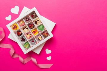 Valentine day composition: sweet candy, with gift boxes with bow and red felt hearts, photo template, background. Top View with copy space