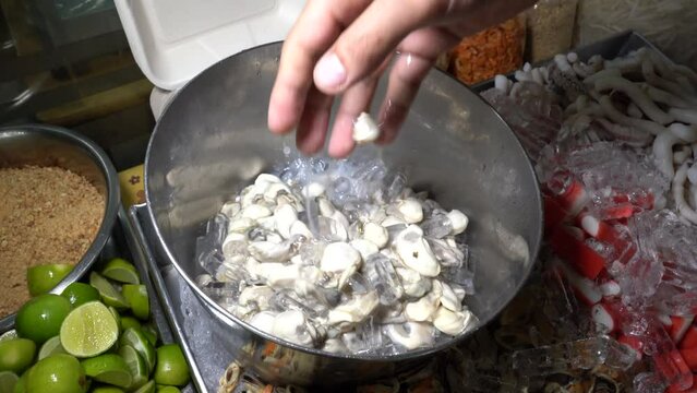 A lot of ingredients for processing and cooking fried oyster omelet such as  crab sticks, mussel, squid, egg, shrimp and prawn  at street food in Thai restaurant.
