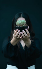 woman holding a cactus
