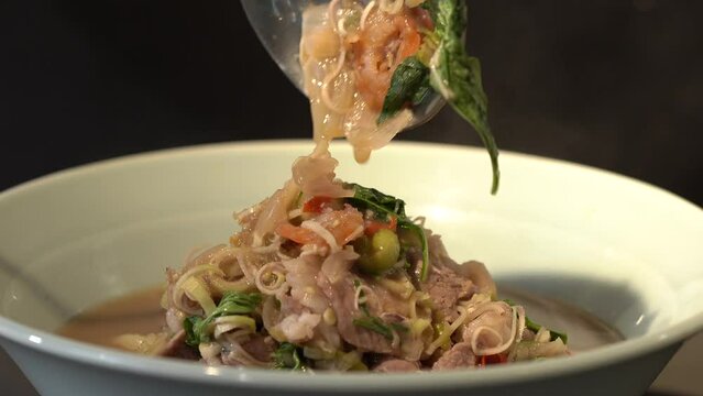 Close up to boiled and fried Pork Thai Menu with Shrimp Paste in white bowl that ready to serve and eat.