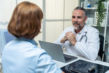 Fototapeta premium Caucasian senior woman visit and consult health problem with doctor. 