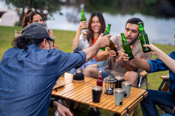 Group of diverse friend having outdoors camping party together in tent.
