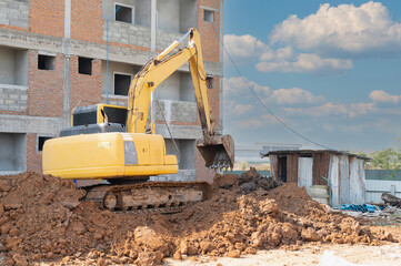 The backhole loader is digging the soil.