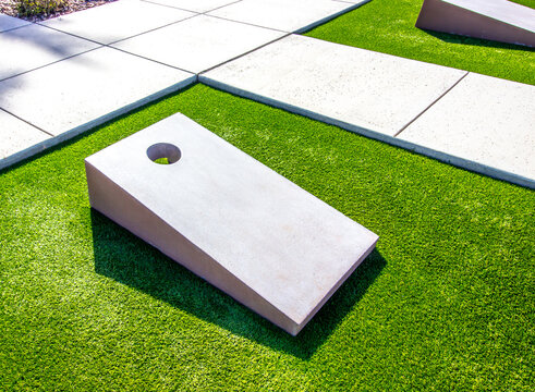 Two Cornhole Boards On Synthetic Turf