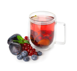 Glass cup of fruit tea with berries and mint on white background
