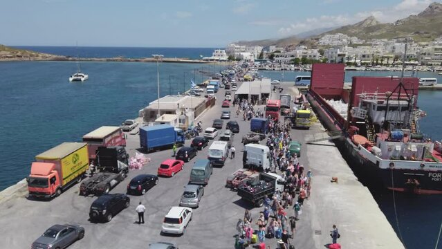 Tourists are waiting to get on a Ferry boat at the port of Paros in Greece