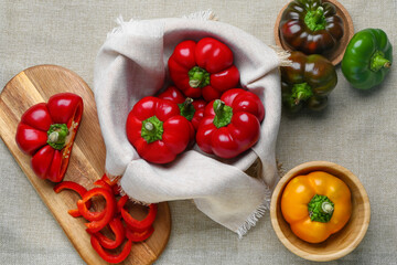 Composition with fresh bell peppers on fabric background