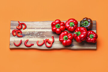 Wooden board of fresh bell peppers on color background