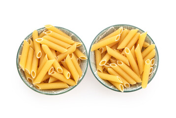 Bowls of raw penne pasta on white background