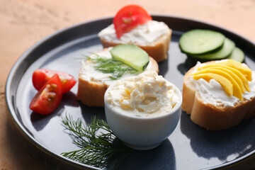 Plate of tasty sandwiches with cream cheese on color background, closeup