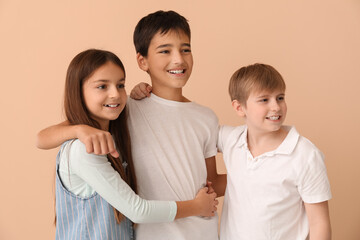 Little friends hugging near beige wall