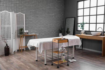 Interior of spa salon with couch and tables