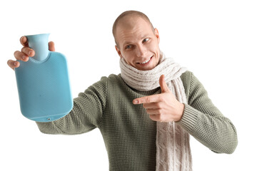 Young man pointing at hot water bottle on white background