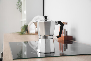 Geyser coffee maker on electric stove in kitchen