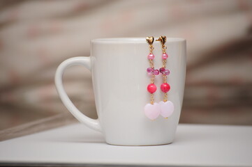 Heart shaped  earrings and coffee