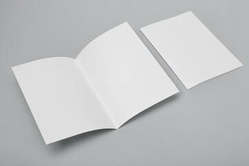 Blank paper folded on gray background