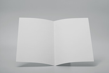 Blank paper folded on gray background