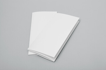Blank paper folded on gray background