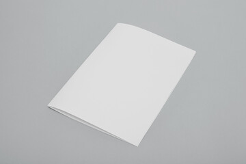 Blank paper folded on gray background