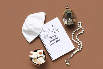 Notebook with text HAPPY ISLAMIC NEW YEAR, hat, sweets, lantern and prayer beads on brown background